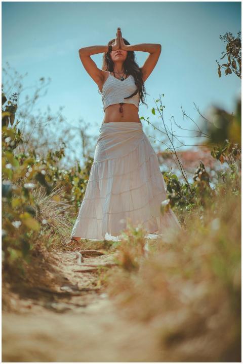Young woman meditating in a peaceful outdoor setti