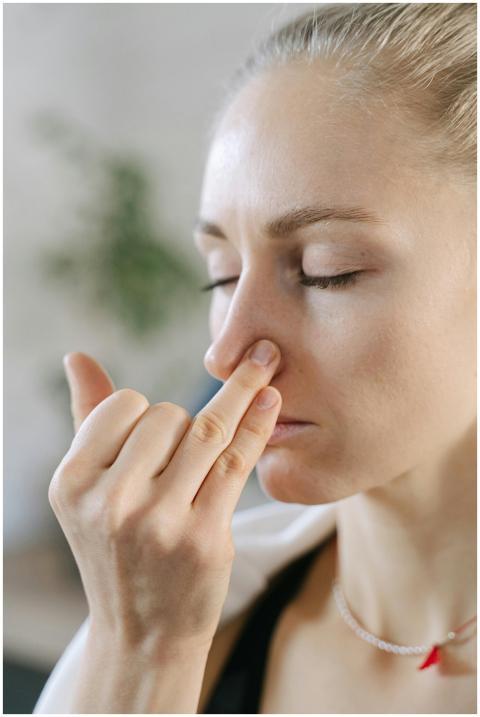 Close-up of a woman doing a breathing exercise wit