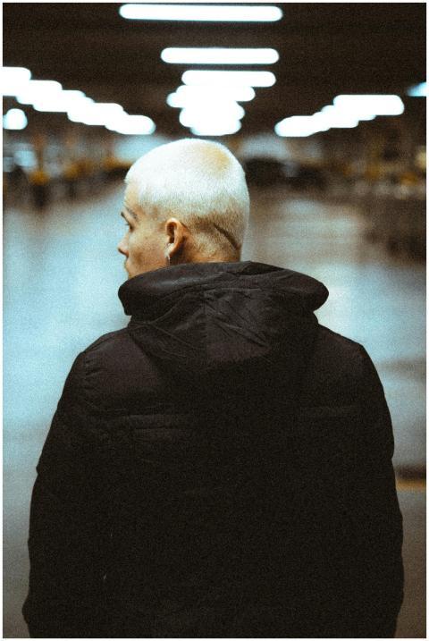 Stylish man with a shaved head wearing a fur jacke