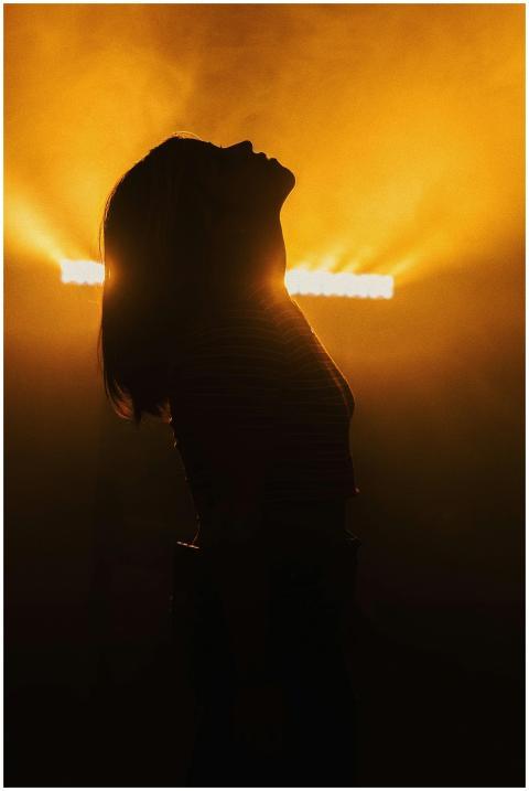 A striking silhouette of a woman with her head bac