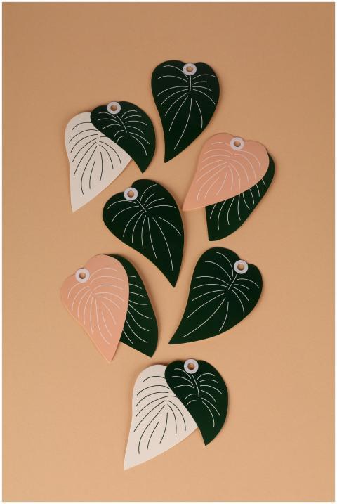 Stylized leaf shapes arranged on a beige backdrop