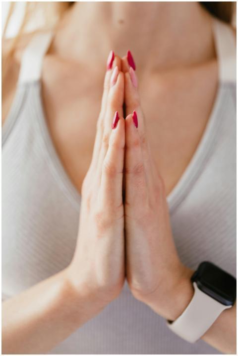 A serene close-up of a woman meditating with palms