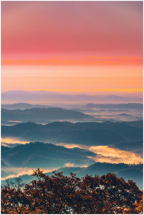 A breathtaking view of rolling mountains at sunset