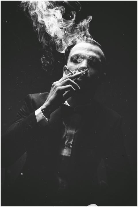 Intense black and white portrait of a man smoking,