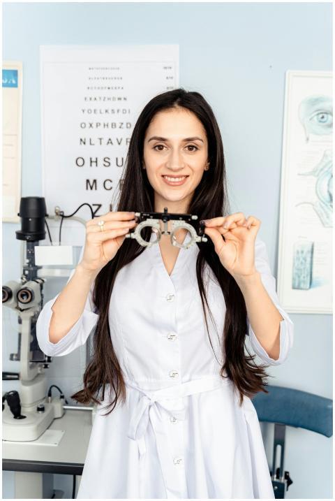 Optometrist smiling while holding optical trial le