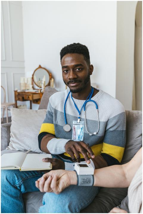 Healthcare worker with stethoscope checking patien