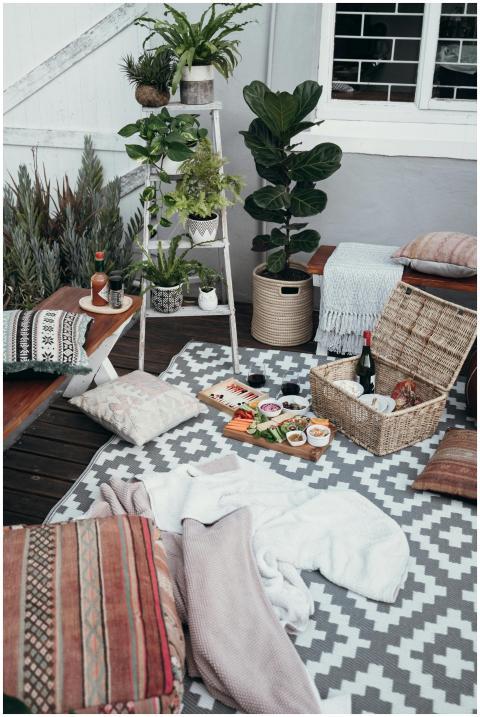 Stylish indoor picnic setting with food and lush p