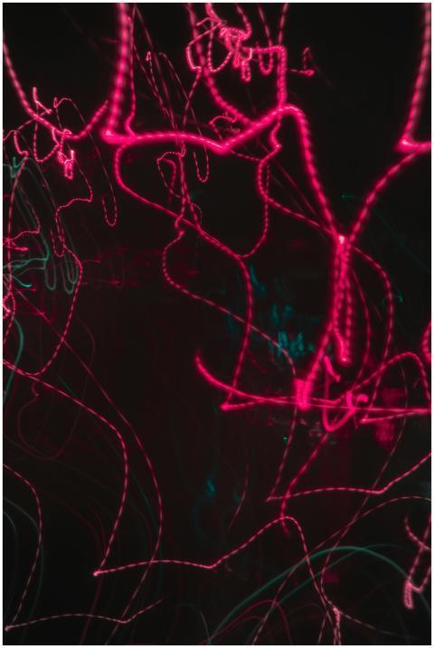 Dynamic neon light trails creating an abstract and