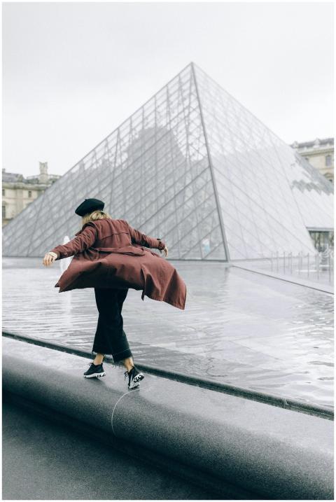 A woman with a beret enjoys a walk by the iconic L