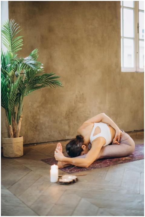 Woman practicing yoga indoors in a serene setting
