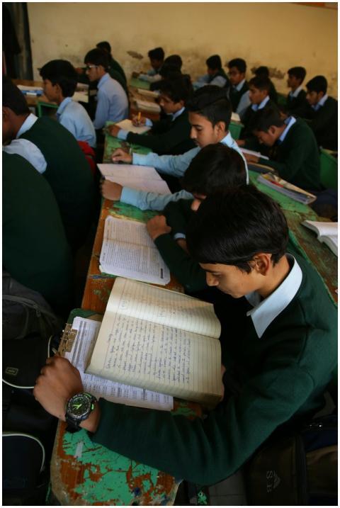 Group of boys reading and studying in a classroom