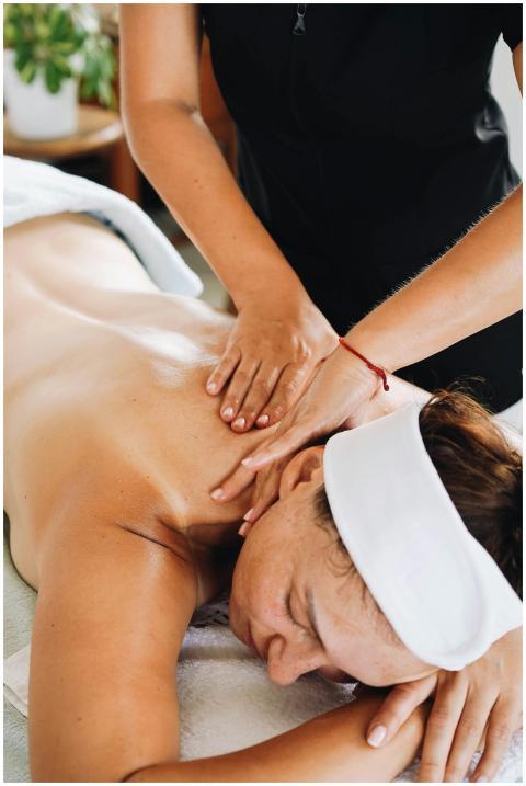 A woman enjoys a calming massage in a relaxing spa