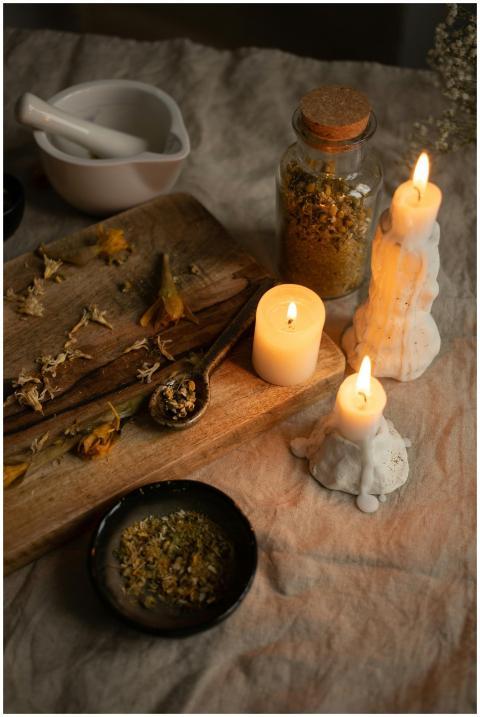 Warm ambiance with candles, dried herbs, and morta