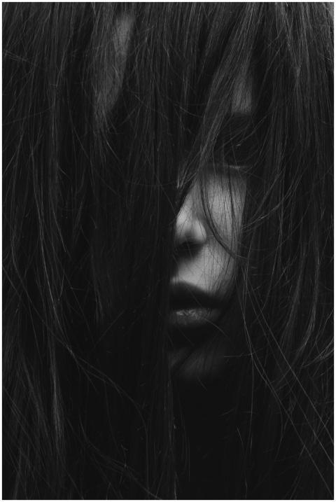 A dark and mysterious portrait of a girl with long