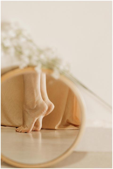 Elegant close-up of bare feet reflected in a mirro