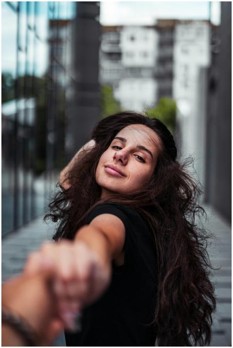 A happy woman with long hair poses playfully in an