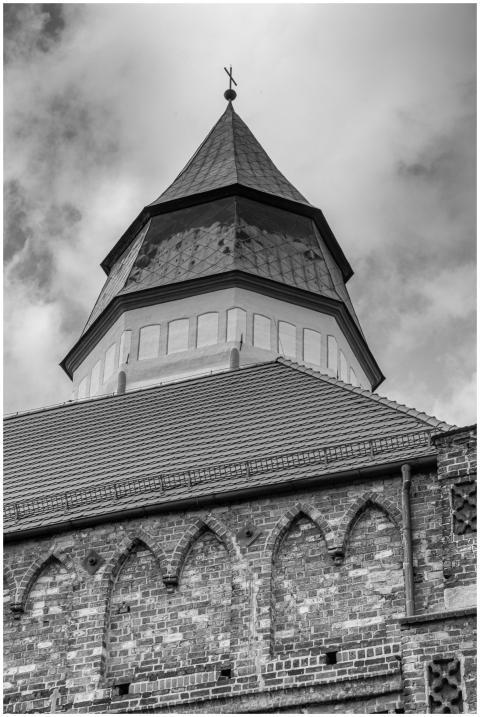 Black and white photo of a Gothic church tower in