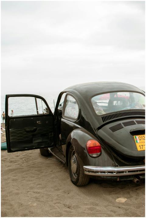 Classic VW Beetle parked on a Ténès beach, evoking