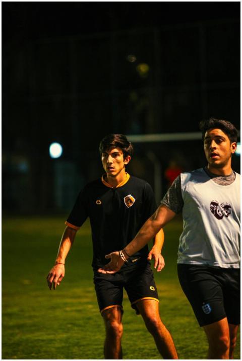 Athletes competing in a nighttime soccer match on
