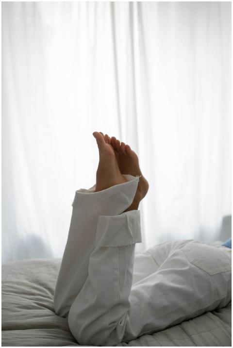 Relaxation at home with legs raised against a whit