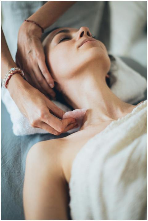 Woman receiving a relaxing gua sha massage in a ca