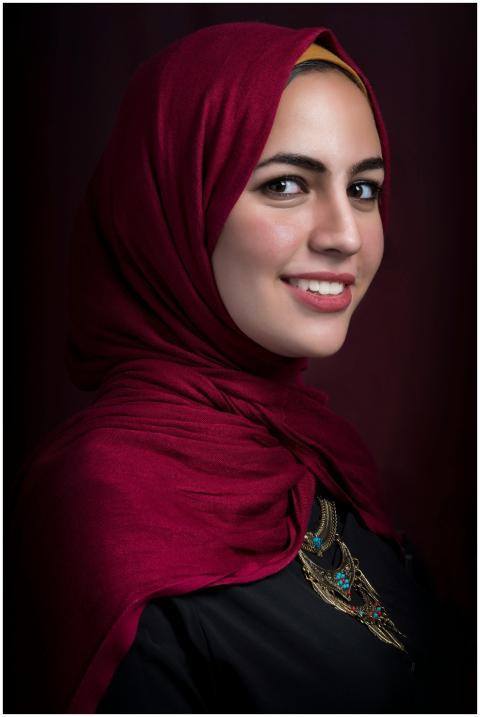 Stunning profile portrait of a woman wearing a red