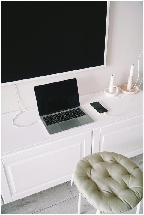 A clean, minimalist workspace featuring a laptop,