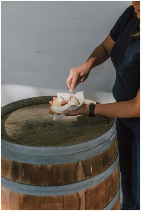 Close-up of a hand spreading cream cheese on a bag