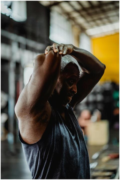 A focused athlete performing a stretch in an indus