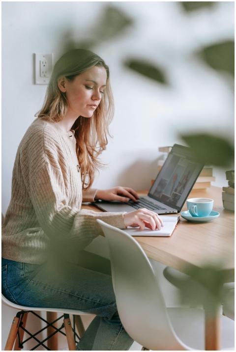 Side view of focused female freelancer reading not