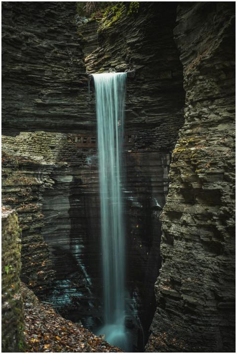 A stunning waterfall flows through a rocky gorge,