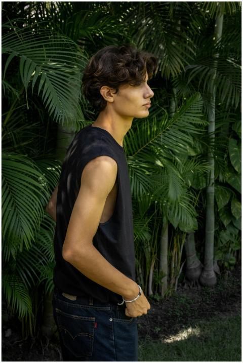 Portrait of a young man standing outdoors surround