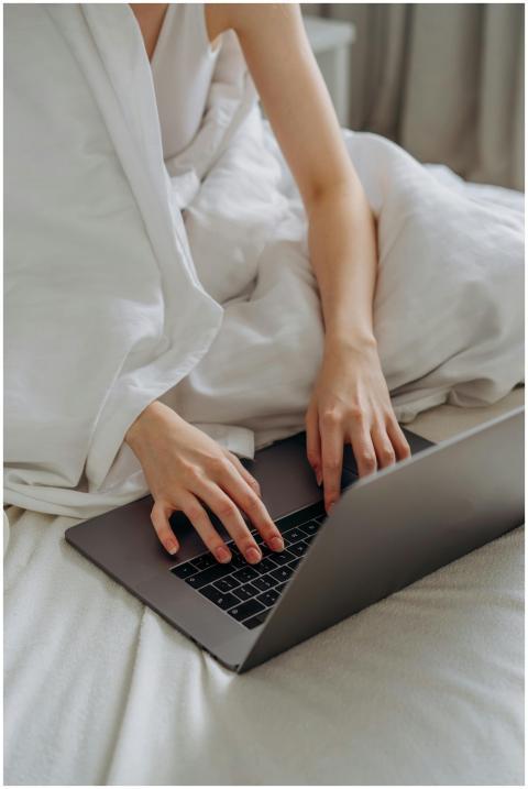 Adult woman comfortably typing on a laptop while s