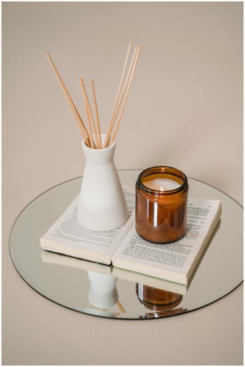 Serene still life of candle and incense on a book