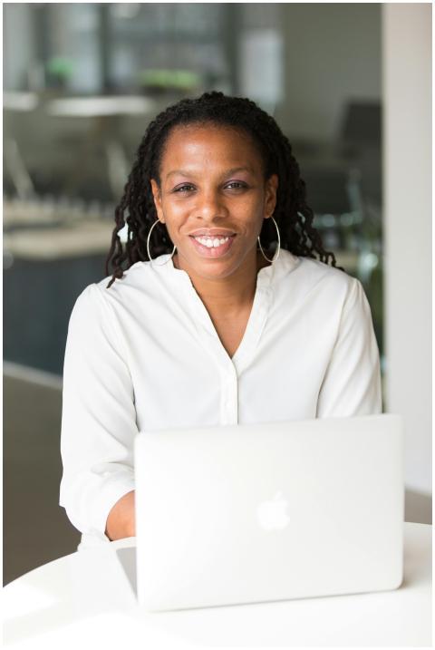 Confident woman smiling while sitting at an office