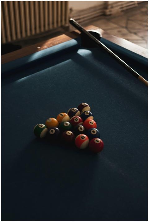 Pool table with billiard balls arranged for a game