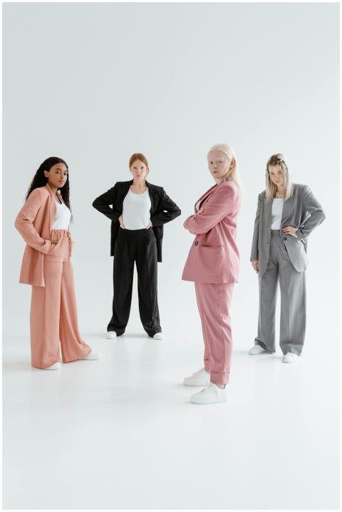 Four diverse women in stylish business suits exudi