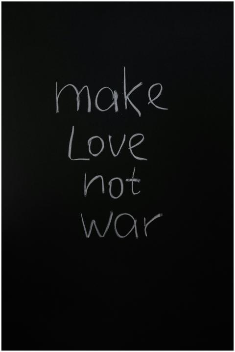 Vertical shot of 'make love not war' handwritten o