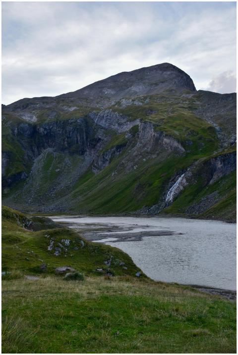 Serene mountain scene with a lake and a small wate