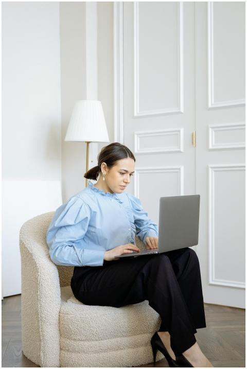 Focused businesswoman using laptop in stylish offi