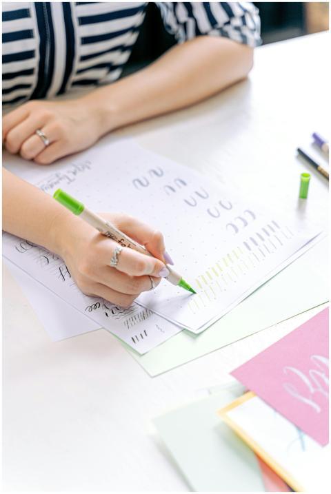 Close-up of a woman practicing hand lettering with