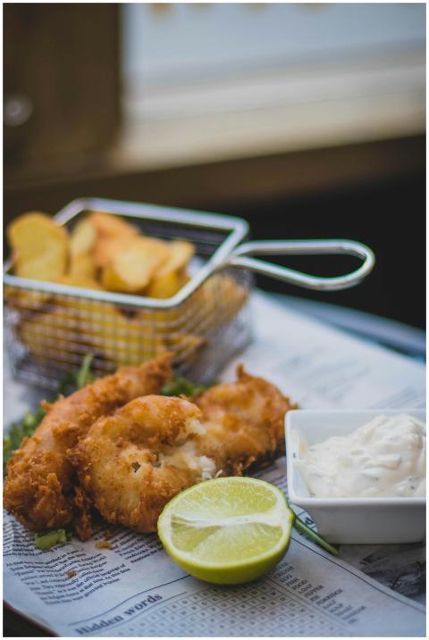 Close-up of crispy fish and chips with tartar sauc