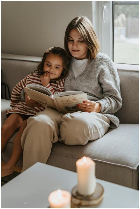 A cozy moment of a mother reading a book to her cu