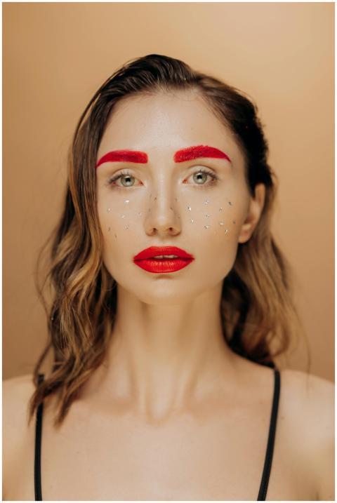Stylish portrait of a woman with bold red makeup a