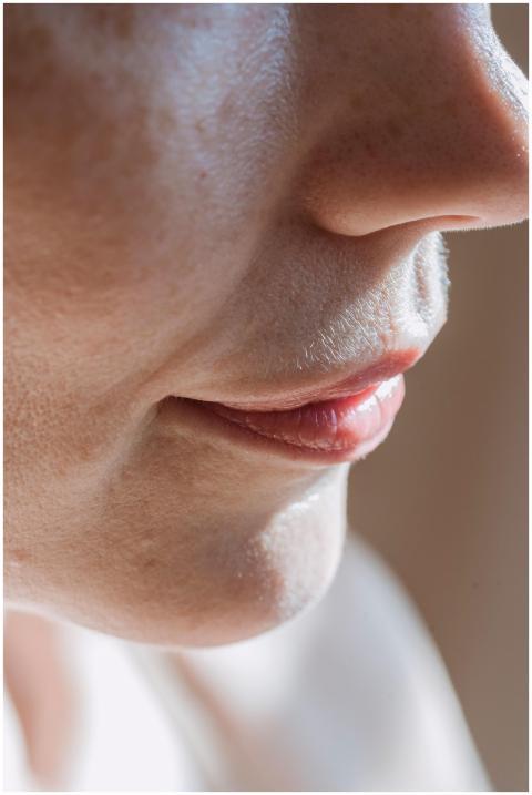 Sunlit close-up of a woman's lips and nose highlig