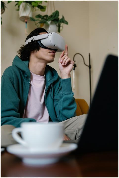 A young man using a VR headset at home, fully imme