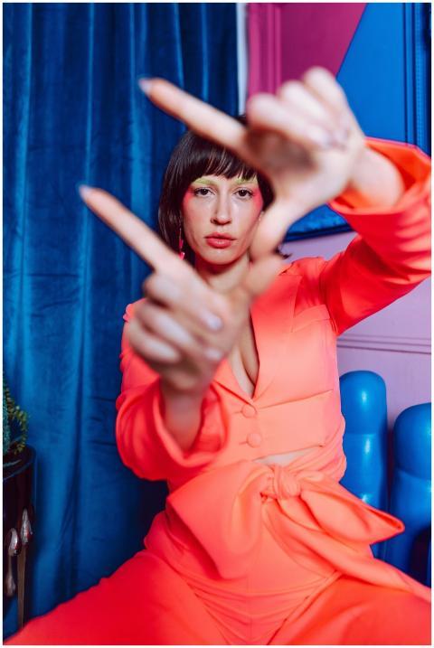 Colorful portrait of a stylish woman posing indoor