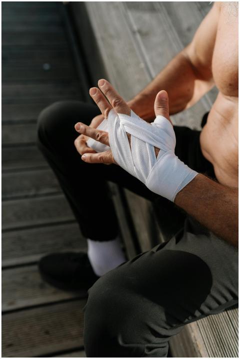 Close-up of athlete wrapping hands with bandages o