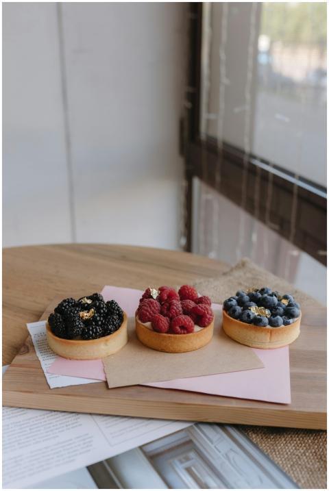 Delicious berry tarts topped with gold leaf, perfe