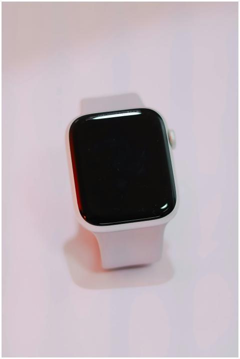 Close-up of a white smartwatch with a blank screen